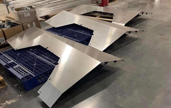 Unassembled fender quarter panels stainless steel parts on Giga Texas factory floor